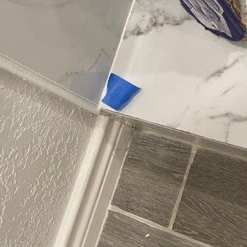 RPS Remodeling And Painting Solutions - poorly trying to cover up wrong grout color, more unfinished tile edges - Drywall Installation & Repair Near Me