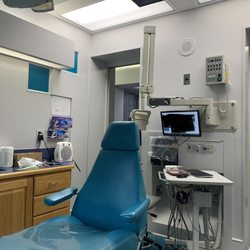 Volunteer Pediatric Dentistry - Exam room, kid-sized chairs and TV's mounted to ceiling with Disney movies playing