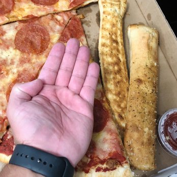 Goodfellas Pizzeria - Just showing how big the slice and folded garlic stick is on this picture - Pizza Near Me - Covington, Kentucky Goodfellas Pizzeria - Just showing how big the slice and folded garlic stick is on this picture - Pizza Near Me - Covington, Kentucky