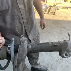 Pisani's Exxon Service - Dominic showing me one of my bad struts.