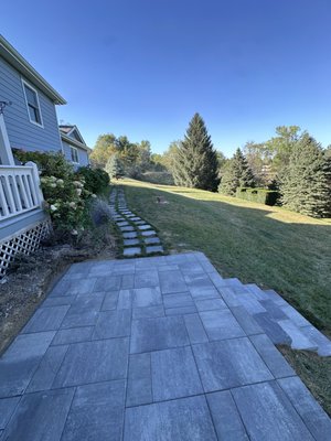 Landings with stepping stones - We created a functional and attractive outdoor space by designing two landing areas connected by a winding walkway made of stepping stones. This thoughtful layout provides convenient access while adding a natural aesthetic to the landscape. The stepping stones guide visitors through the garden, enhancing the overall charm and inviting them to explore the beauty of the property.