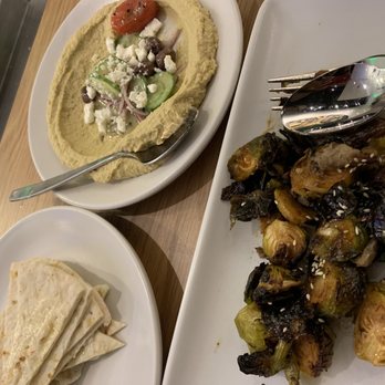 True Food Kitchen - Their signature humus with salad and perfectly Roasted Brussel sprouts - New American Near Me - Oakbrook, Illinois True Food Kitchen - Their signature humus with salad and perfectly Roasted Brussel sprouts - New American Near Me - Oakbrook, Illinois