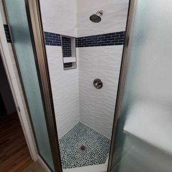 Ramos Home Care Construction - New shower pan with glass floor tiles, 3d wall tiles with a band. Also installed new frosted glass enclosure. - General Contractors Near Me