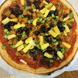Cauliflower pizza crust with red sauce, spicy red sauce, bell peppers, olives, pineapple and spicy chicken sausage. Cauliflower pizza crust with red sauce, spicy red sauce, bell peppers, olives, pineapple and spicy chicken sausage.