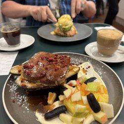 Dizengoff - French toast with grilled banana and fresh fruit; eggs benedict in background