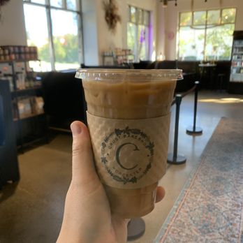 Crust Artisan Bakeshop - a hand holding a cup of iced coffee - Bakeries Near Me - Worcester, Massachusetts