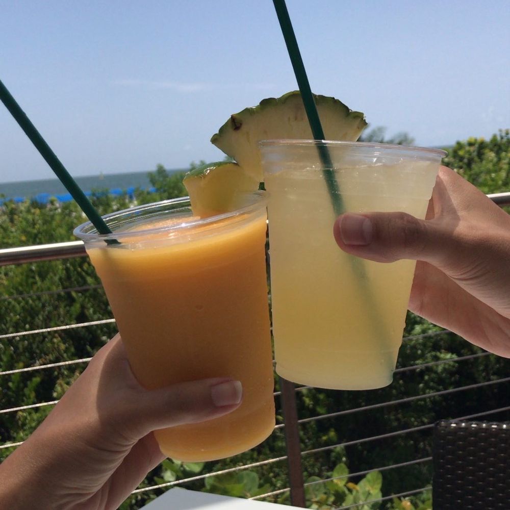The Deck @ 560 - two people toasting with drinks - New American Near Me - Marco Island, Florida The Deck @ 560 - two people toasting with drinks - New American Near Me - Marco Island, Florida