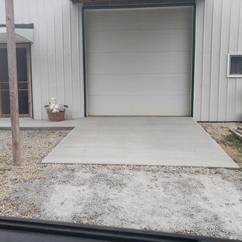 Brown Star Landscaping - a garage with a white garage door - Landscaping Near Me Brown Star Landscaping - a garage with a white garage door - Landscaping Near Me