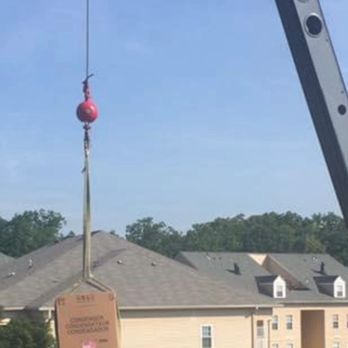 Clean Air - AC condenser unit installed on a roof by a crane - Heating & Air Conditioning/HVAC Near Me