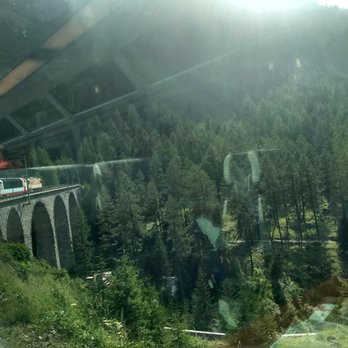 Glacier Express - reflections from the seats as the train passes over a viaduct - Transportation Near Me