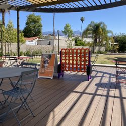 Playhouse Village Park - The Van Halen pavilion with giant connect four and shaded tables.