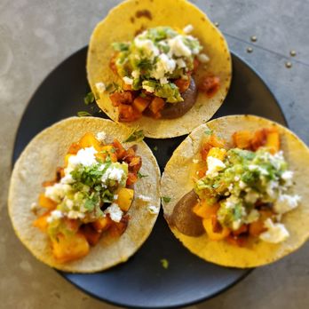 Organic Krush Kitchen & Eatery - Sweet potato tacos with pineapple, black bean, guacamole, feta, cilantro, and chili sauce. - Juice Bars & Smoothies Near Me - Roslyn, New York Organic Krush Kitchen & Eatery - Sweet potato tacos with pineapple, black bean, guacamole, feta, cilantro, and chili sauce. - Juice Bars & Smoothies Near Me - Roslyn, New York
