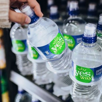 Yesway - a hand picking up a bottle of water - Convenience Stores Near Me - Hamilton, Texas