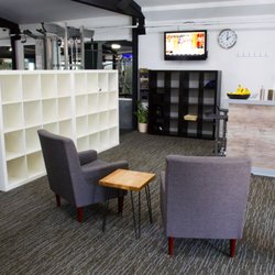Uptown Fitness - Lobby: bar, chairs, television, cubbies.