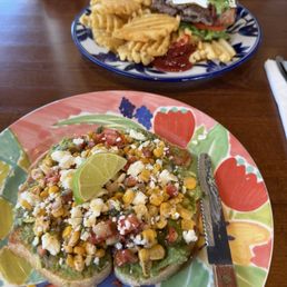 Elote avocado toast and The Smashburger with fries Elote avocado toast and The Smashburger with fries
