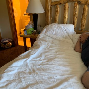 Discovery Lodge - Messy bed! But you can see the rustic style. - Hotels Near Me - Estes Park, Colorado