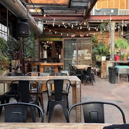 a patio with tables and chairs