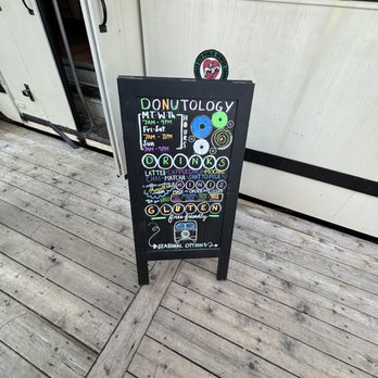 Donutology - a sign on a wooden floor - Donuts Near Me - Kansas City, Missouri