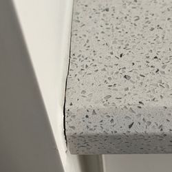 Tuscany Tile Design Studio - cracked grout instead of caulk at cabinet edge