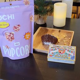 a table with a bag of hot chocolate and a lit candle