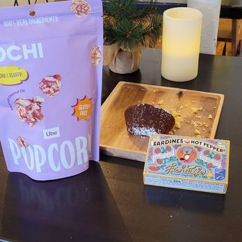 Cafe Mornings & Market - a table with a bag of hot chocolate and a lit candle - Breakfast & Brunch Near Me - Arkville, New York