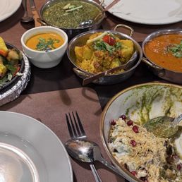 Shrimp tandoor on sizzling skillet, paneer, aloo gabi, chicken tikka masala and 3/4 eaten samosa chat Shrimp tandoor on sizzling skillet, paneer, aloo gabi, chicken tikka masala and 3/4 eaten samosa chat