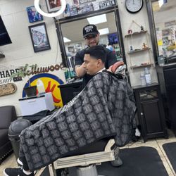 Razor Sharp Barbershop - Mauricio the barber action shot. Mid high taper fade.