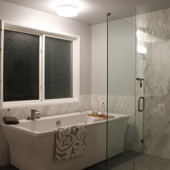 Landin Construction - a bathtub and shower in a bathroom - General Contractors Near Me - Tukwila, Washington Landin Construction - a bathtub and shower in a bathroom - General Contractors Near Me - Tukwila, Washington