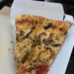 It's a slice of cold vegetable pizza, I had 2 but couldn't eat them bc they were cold... only took one bite.