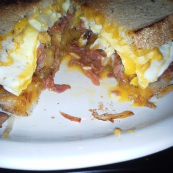 The Pan - Pastrami breakfast sandwich cut in half. Has pastrami, eggs and hashbrown on try bread! Yum! - Pizza Near Me - Gardena, California The Pan - Pastrami breakfast sandwich cut in half. Has pastrami, eggs and hashbrown on try bread! Yum! - Pizza Near Me - Gardena, California