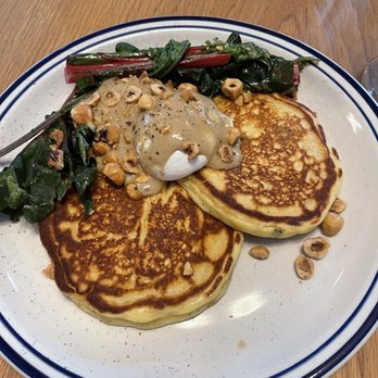afternoon - Johnny Cakes with poached egg, gravy, peanuts and sautéed chard - New American Near Me - Gainesville, Florida afternoon - Johnny Cakes with poached egg, gravy, peanuts and sautéed chard - New American Near Me - Gainesville, Florida