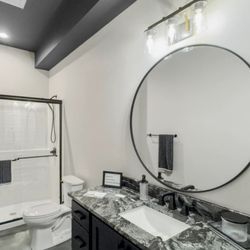 Econo Glass Systems - Sliding Shower Door, Round Vanity Mirror, and Bathroom Accessories in Matte Black