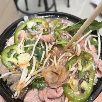 Pho Thai Son - UT Campus - a person holding a bowl of food - Vietnamese Near Me - Austin, Texas Pho Thai Son - UT Campus - a person holding a bowl of food - Vietnamese Near Me - Austin, Texas