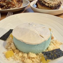 Dolar de arena dessert ($16)-- white chocolate sand dollar, coconut mousse, almond praline + passion fruit mango cream inside