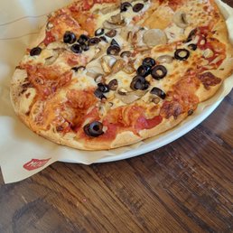 a pizza with olives and mushrooms