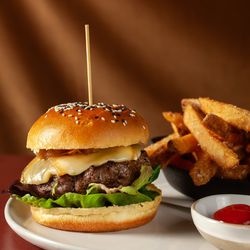 The Ridge - The Ridge Burger, crafted with bison and in-house dry-aged beef, pickles, onions, greens, and raclette, on a brioche bun, with fries