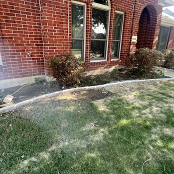 Green King Lawn Care - a brick house with a flower bed - Lawn Services Near Me Green King Lawn Care - a brick house with a flower bed - Lawn Services Near Me