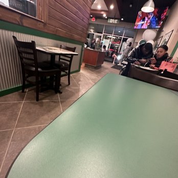 Wingstop - a person sitting at a table in a restaurant - Chicken Wings Near Me - Pittsburgh, Pennsylvania Wingstop - a person sitting at a table in a restaurant - Chicken Wings Near Me - Pittsburgh, Pennsylvania