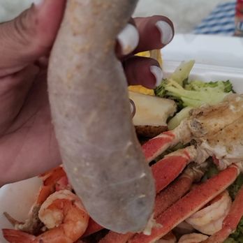 Louisiana Seafood - a person holding a hot dog in their hand - Seafood Markets Near Me - Atlanta, Georgia Louisiana Seafood - a person holding a hot dog in their hand - Seafood Markets Near Me - Atlanta, Georgia