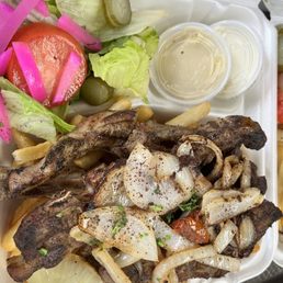 a tray of food with fries and salad a tray of food with fries and salad