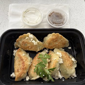 Pierogi One - Spinach & feta pan-fried pierogi with caramelized onions and sour cream. - Polish Near Me - Pompano Beach, Florida