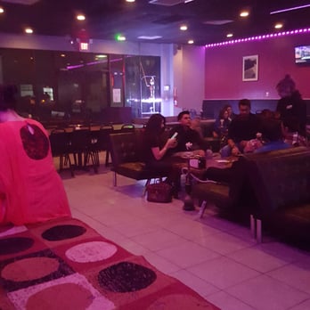 Glow Hookah Lounge - a group of people sitting in a lounge area - Hookah Bars Near Me - Houston, Texas