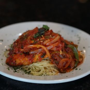 Mezza Luna - Chicken breast topped with our signature zesty pomodoro sauce, green peppers and onions served on a bed of spaghetti. - Italian Near Me - The Villages, Florida