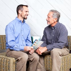 Queen Anne Hilltop Dental - Dr. Max discussing care with a loyal patient.