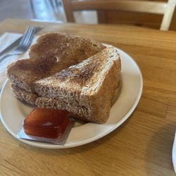 Sunset Grill - Toasted brown bread with butter along strawberry jam