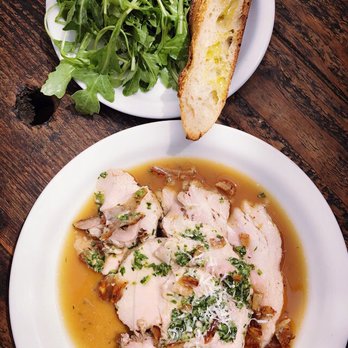 Gjusta - Porchetta plate served with arugula greens and a slice of toasted bread - Bakeries Near Me - Venice, California