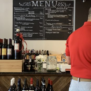 Z Place for Wine & Cheese - a man standing in front of a menu - Cheese Shops Near Me - Montgomery, Ohio Z Place for Wine & Cheese - a man standing in front of a menu - Cheese Shops Near Me - Montgomery, Ohio