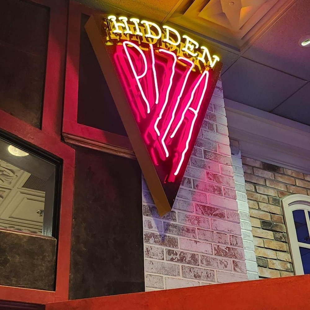 Hidden Pizza - a neon sign on a brick building - Pizza Near Me - Reno, Nevada Hidden Pizza - a neon sign on a brick building - Pizza Near Me - Reno, Nevada