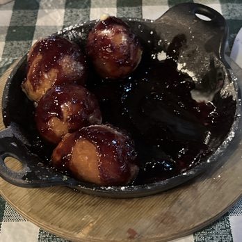 Rodeo Goat - Goat balls (Bavarian crème-filled balls, topped with blackberry compote and powdered sugar)... - Bars Near Me - Fort Worth, Texas