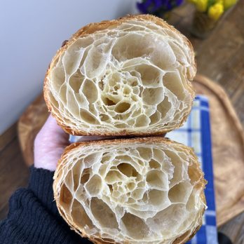 Charlotte Patisserie - a person holding a piece of bread - Desserts Near Me - Brooklyn, New York Charlotte Patisserie - a person holding a piece of bread - Desserts Near Me - Brooklyn, New York